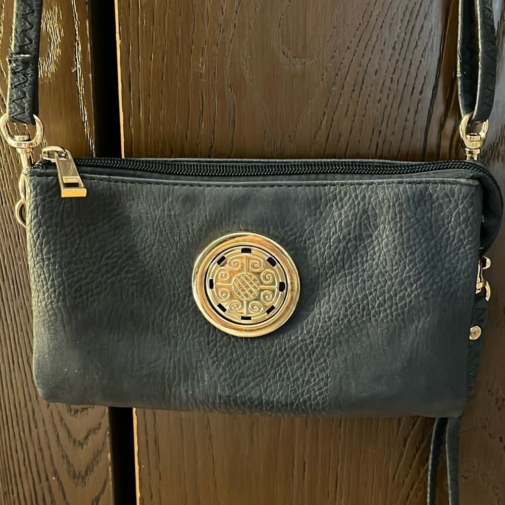 No brand navy blue leather small handbag. Gold metal design on the front.